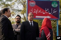 Salman Sardar, center, a lawyer of Pakistan's former Prime Minister Imran Khan's legal team, talks with colleagues as he arrives for a hearing at a special court in Adiyala prison, in Rawalpindi, Pakistan, Dec. 12, 2023.