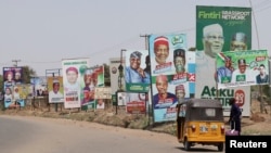 FILE - Electoral campaign posters are seen on Numan road ahead of Nigeria's presidential elections, in Yola, Nigeria, Feb. 23, 2023.