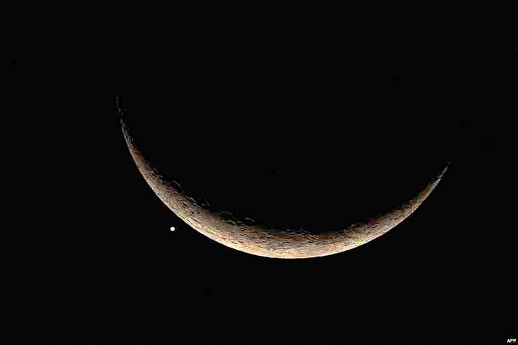 The crescent moon and Venus are pictured in Bangkok, following a lunar occultation of the second planet from the sun.