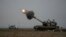 An Israeli mobile artillery unit fires a shell from southern Israel towards the Gaza Strip, in a position near the Israel-Gaza border Dec. 14, 2023.