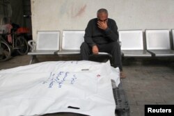 A mourner reacts next to the bodies of Palestinians killed in an Israeli strike at Abu Yousef al-Najjar hospital in Rafah, in the southern Gaza Strip, May 5, 2024.