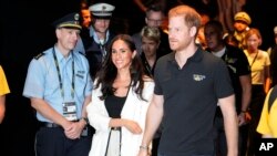 FILE—Britain's Prince Harry, right, and Meghan, Duchess of Sussex, arrive to a wheelchair basketball match at the Invictus Games in Duesseldorf, Germany, September 13, 2023.