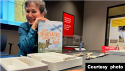 Writer and paleontologist Jingmai O’Connor holds WHEN DINOSAURS CONQUERED THE SKIES , published by The Quarto Group (Photo: Lisa Fielding)