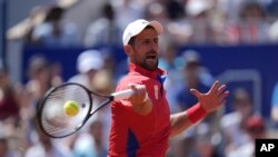 Serbia's Novak Djokovic returns the ball to Spain's Rafael Nadal during their men's singles second round match at the Roland Garros stadium at the 2024 Summer Olympics, July 29, 2024, in Paris, France. 