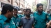 Police escort reporter Shamsuzzaman Shams (C), who has been arrested and charged under the Digital Security Act, to a court in Dhaka, Bangladesh, March 30, 2023.