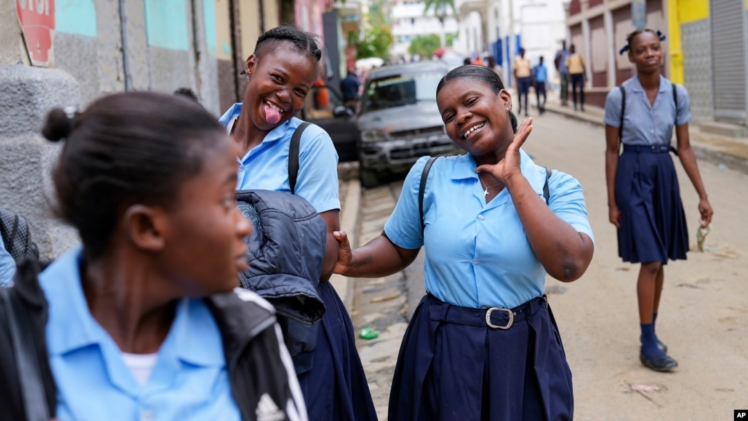 Students strike poses at the end of their school day, in Cap-Haitien, Haiti, April 17, 2024.