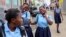Students strike poses at the end of their school day, in Cap-Haitien, Haiti, April 17, 2024.