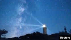 FILE - A meteor streaks in the night sky during the annual Perseid meteor shower on the island of Lastovo, Croatia, Aug. 12, 2023. (REUTERS/Antonio Bronic)