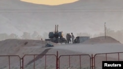 资料照片：视频截图显示了在伊朗伊斯法罕扎尔丹詹地区的一座核设施前站岗的军事人员。（2024年4月19日）
