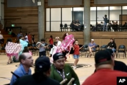Community members dance to the drum during an open drum and dance night at Minneapolis American Indian Center, July 10. 2024, in Minneapolis, Minnesota.