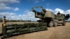 FILE - U.S. soldiers prepare to load the Army Tactical Missile System onto the High Mobility Artillery Rocket System in Queensland, Australia, on July 26, 2023, in this image provided by the U.S. Army. Ukraine is asking NATO members for long-range weapons such as the ATACMS.