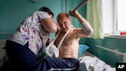 Vitalii Shpalin, 60, recovers in a hospital in Kherson region, June 12, 2023, after he was shot while fleeing from a flooded village on the east bank of the Dnipro River in Ukraine.