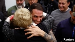 Spanish national Santiago Sanchez embraces his mother upon his arrival at Adolfo Suarez Madrid-Barajas Airport in Madrid, Spain, Jan. 2, 2024, after his release from an Iranian prison.