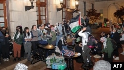 FILE - Pro-Palestinian student protesters lock arms at the entrance to Hamilton Hall on the campus of Columbia University, on April 30, 2024, in New York.