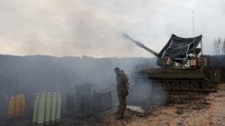 An Israeli soldier stands by a mobile artillery unit, near the Israel-Lebanon border, in northern Israel, Jan. 15, 2024.