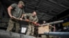 Members of the company tactical group "Steppe Wolves" of the Voluntary Formation of the Zaporizhzhia Territorial Community disassemble a shell for a BM-21 Grad multiple launch rocket system in Zaporizhzhia region, Ukraine, April 26, 2024.
