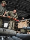 Members of the company tactical group "Steppe Wolves" of the Voluntary Formation of the Zaporizhzhia Territorial Community disassemble a shell for a BM-21 Grad multiple launch rocket system in Zaporizhzhia region, Ukraine, April 26, 2024.