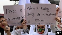 FILE - Supporters of former Pakistani Prime Minister Imran Khan hold placards during a peace rally following a mosque suicide blast inside police headquarters, in Peshawar, Feb. 3, 2023.