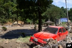 The wreckage of a car lies in a village affected by a flash flood in Tanah Datar, West Sumatra, May 12, 2024.