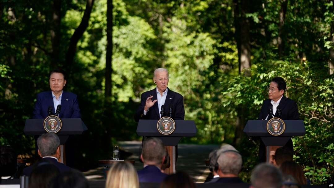 South Korea's President Yoon Suk Yeol, left, and Japan's Prime Minister Fumio Kishida, right, listen as President Joe Biden speaks during a news conference, Aug. 18, 2023, at Camp David, the presidential retreat, near Thurmont, Md.