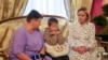 FILE — In this photo taken in Moscow, Russia, a Ukrainian boy repatriated from Russia to Ukraine sits next to his grandmother, left, and Russian Commissioner for Children's Rights Maria Lvova-Belova, Oct. 13, 2023. (Qatar's Ministry of Foreign Affairs/Handout via Reuters)