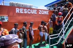 Pengungsi Rohingya menaiki kapal Badan Pencarian dan Pertolongan Nasional (BASARNAS) setelah mereka diselamatkan dari perahu mereka yang terbalik di perairan sekitar 16 mil laut (29 kilometer) lepas pantai barat Aceh, 21 Maret 2024. (Zahlul AKBAR/AFP)