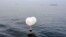 A balloon carrying various objects including what appeared to be trash, believed to have been sent by North Korea, is pictured at the sea off Incheon, South Korea, June 9, 2024. 