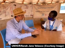 In this undated photo provided by UNHCR, radio journalist Jabrallah Tia interviews former UNHCR South Sudan Representative Arafat Jamal.