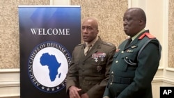 US Marine Gen. Michael Langley, head of US Africa Command, left, speaks to reporters at a conference of military chiefs from across Africa, with Lt. Gen. Placid Segokgo, Botswana’s commander of the defense force, June 25, 2024 in Gaborone, Botswana.