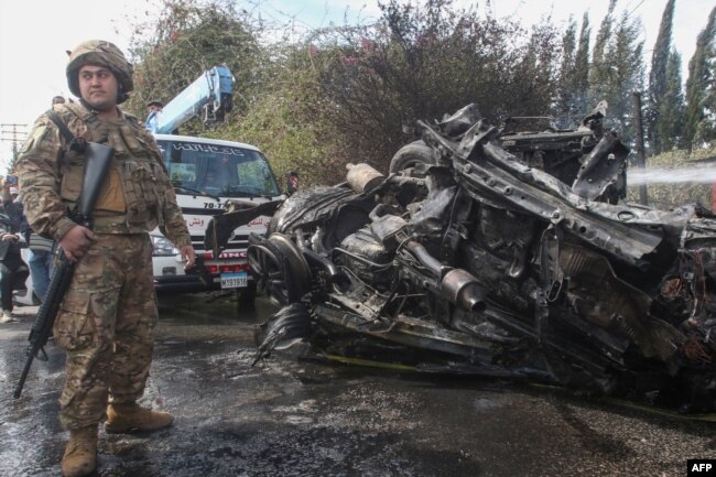 A Lebanese army soldier secures the site of an Israeli strike in Lebanon's southern area of Tyre, March 13, 2024.