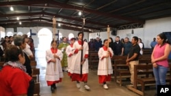 Los monaguillos encabezan la procesión de apertura en la Inmaculada Concepción de María, La Carpio, iglesia católica donde la mayoría de la congregación está compuesta por exiliados y refugiados nicaragüenses, en San José, Costa Rica, el domingo 19 de febrero de 2023.