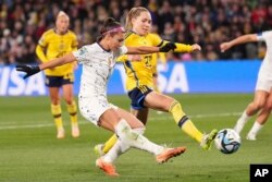 The United States' Sophia Smith, left, takes a shot at goal during the Women's World Cup round-of-16 soccer match between Sweden and the United States in Melbourne, Australia, on Aug. 6, 2023.