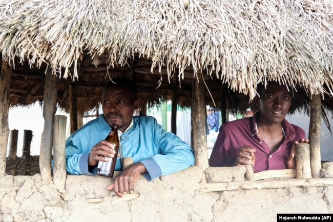 Benson Muhereza enjoys tonto at a local bar in Majengo village, Mbarara, Uganda, Dec. 10, 2023. (AP Photo/Hajarah Nalwadda)