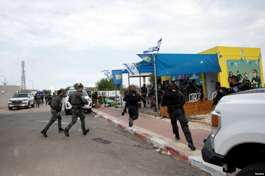 Miembros de la policía fronteriza de Israel corren hacia refugios luego de que las sirenas anunciaran ataques de misil cerca de Sderot, al sur del país.