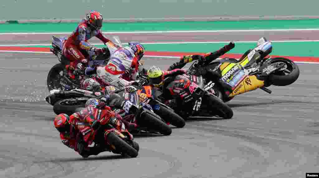 Riders crash at the start of the Moto Grand Prix de Catalunya at the Circuit de Catalunya in Montmelo, Barcelona, Spain.
