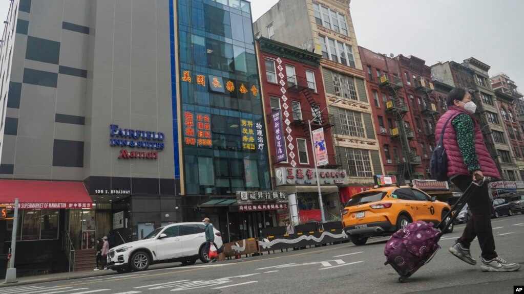 A six story glass facade building, second from left, is believed to be the site of a foreign police outpost for China in New York's Chinatown, Monday April 17, 2023. (AP Photo/Bebeto Matthews)