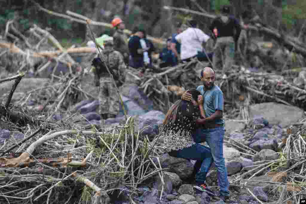 Relatives of police officer Jorge Alberto Ladrón de Guevara react as rescuers recover his body in Alto Lucero, Veracruz, Mexico, July 2, 2024.&nbsp;State authorities said he died in a car accident while checking damaged caused by heavy rain.