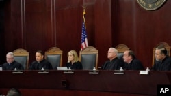 FILE - Arizona Supreme Court Justices listen to oral arguments on April 20, 2021, in Phoenix. The court ruled on April 9, 2024, that the state can enforce its long-dormant law criminalizing all abortions except when a mother’s life is at stake. 