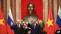 Russian President Vladimir Putin, left, and Vietnam's President To Lam pose for photos at the Presidential Palace in Hanoi, Vietnam, June 20, 2024. 