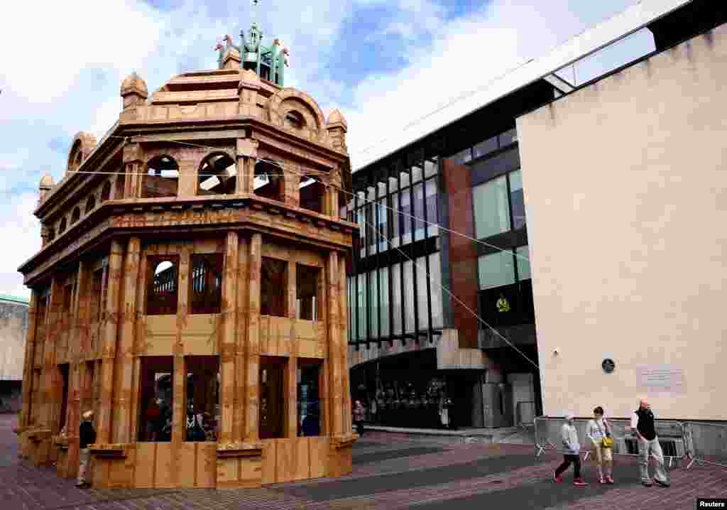People visit a building made entirely from cardboard boxes designed by French artist Olivier Grossetete, which forms part of the Novum Summer Festival in Newcastle, Britain, Aug. 12, 2023. 