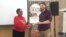Tanaka Murerwa receiving an attendence certificate from Africa Check representative Keegan Leech