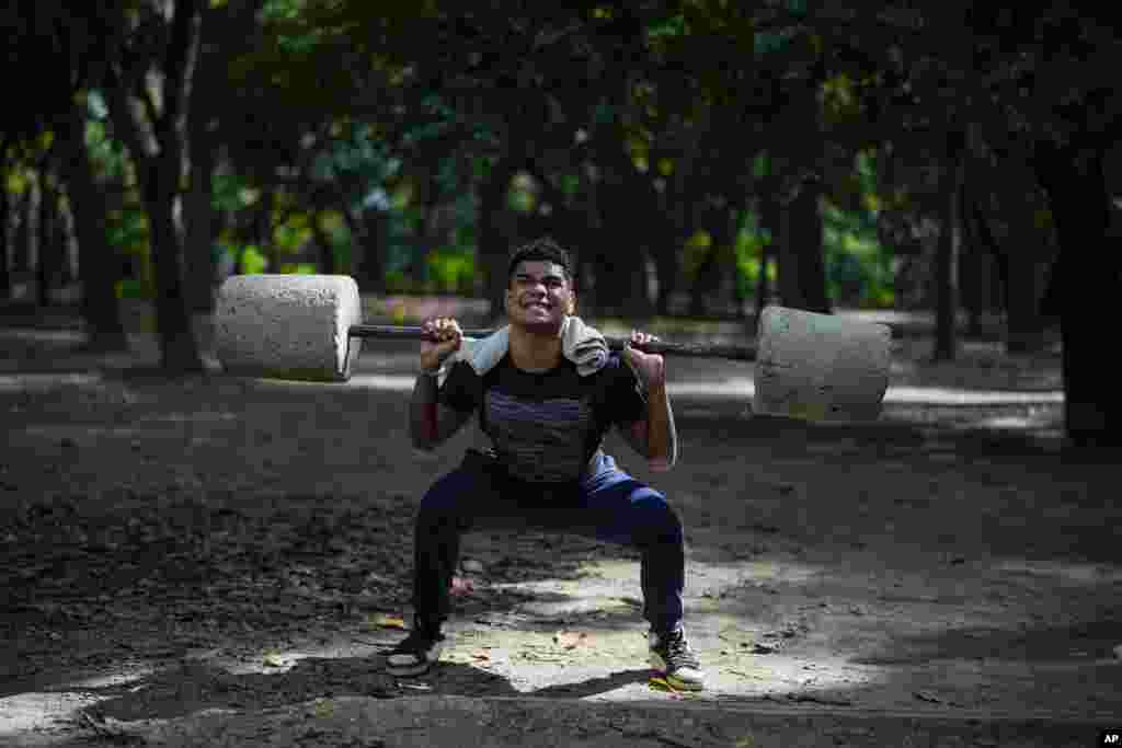 Daniel Fonseca, 15, lifts blocks of cement at a public gym set up at Los Caobos Park in Caracas, Venezuela.