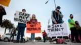 FILE - Supporters of Net Neutrality gather on Nov. 28, 2017, in Los Angeles, California, to protest the FCC's decision to repeal it. On Thursday, the FCC voted to reinstate net neutrality rules and reassume regulatory oversight of broadband internet.