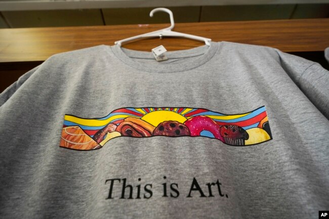 A T-shirt showing the painting displayed outside Leavitt's Country Bakery, is displayed Thursday, April 13, 2023, in Conway, N.H. (AP Photo/Robert F. Bukaty)