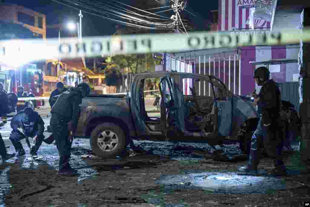Police inspect a truck that exploded outside an office used by the government&#39;s National Service for Attention for People Deprived of Liberty (SNAI), which runs the jail system, in Quito, Ecuador.