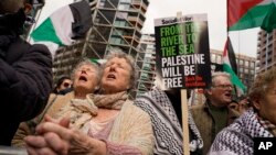 Demonstrators hold flags and placards as they attend a march in support of the Palestinian people in Gaza, in London, March 9, 2024.