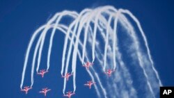 Indian Air Force&#39;s aerobatic team Suryakiran performs maneuvers on the first day of the Aero India 2023 at Yelahanka air base in Bengaluru.