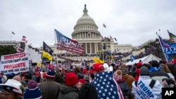 FILE - Supporters of President Donald Trump rally at the U.S. Capitol in Washington on Jan. 6, 2021. 