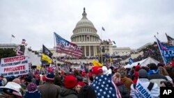 FILE - Supporters of President Donald Trump rally at the U.S. Capitol in Washington on Jan. 6, 2021.