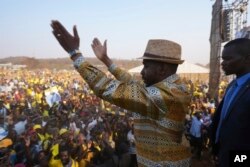 Zimbabwe's main opposition leader, Nelson Chamisa, is surrounded by security as he leaves a campaign rally in Harare on Aug 21, 2023.